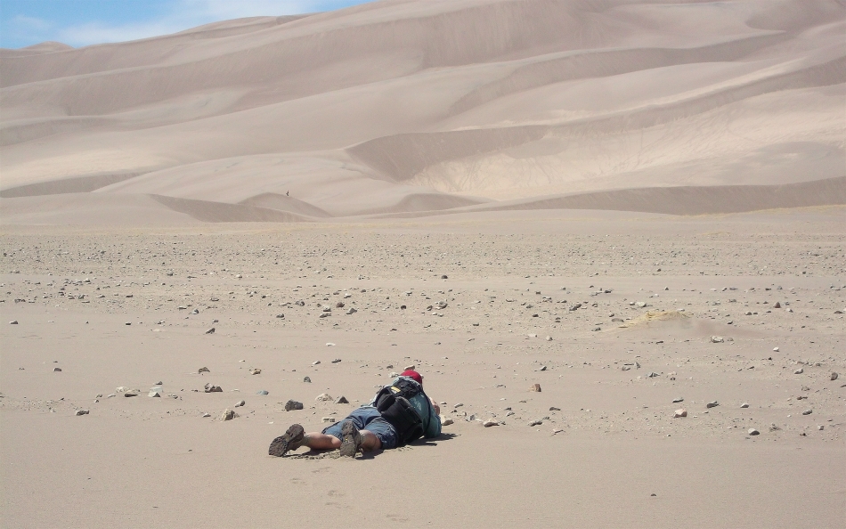 Always the curious rover, yours truly gets down and dirty to photograph rocks at the Great Sand Dunes National Park. Photo by Scott Smith
